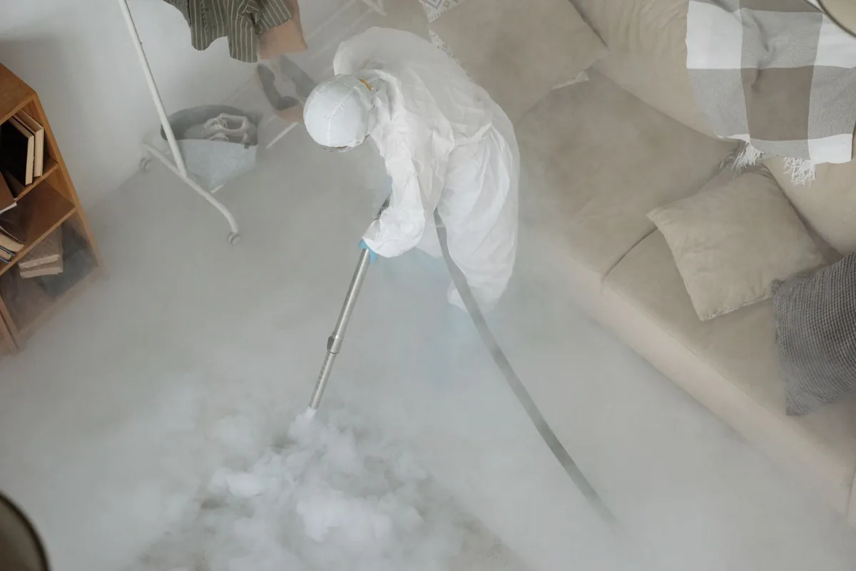 Biohazard cleanup technician in protective equipment, Justin, TX